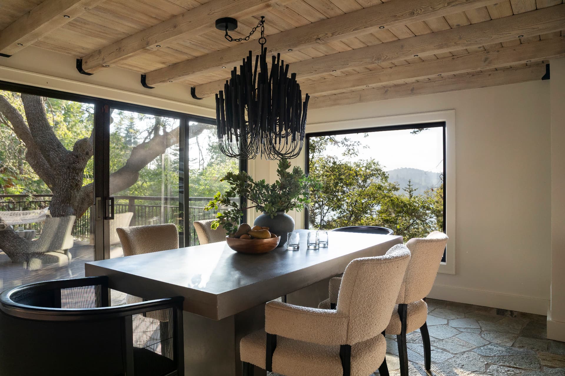 Dining room surrounded by windows and oak branches